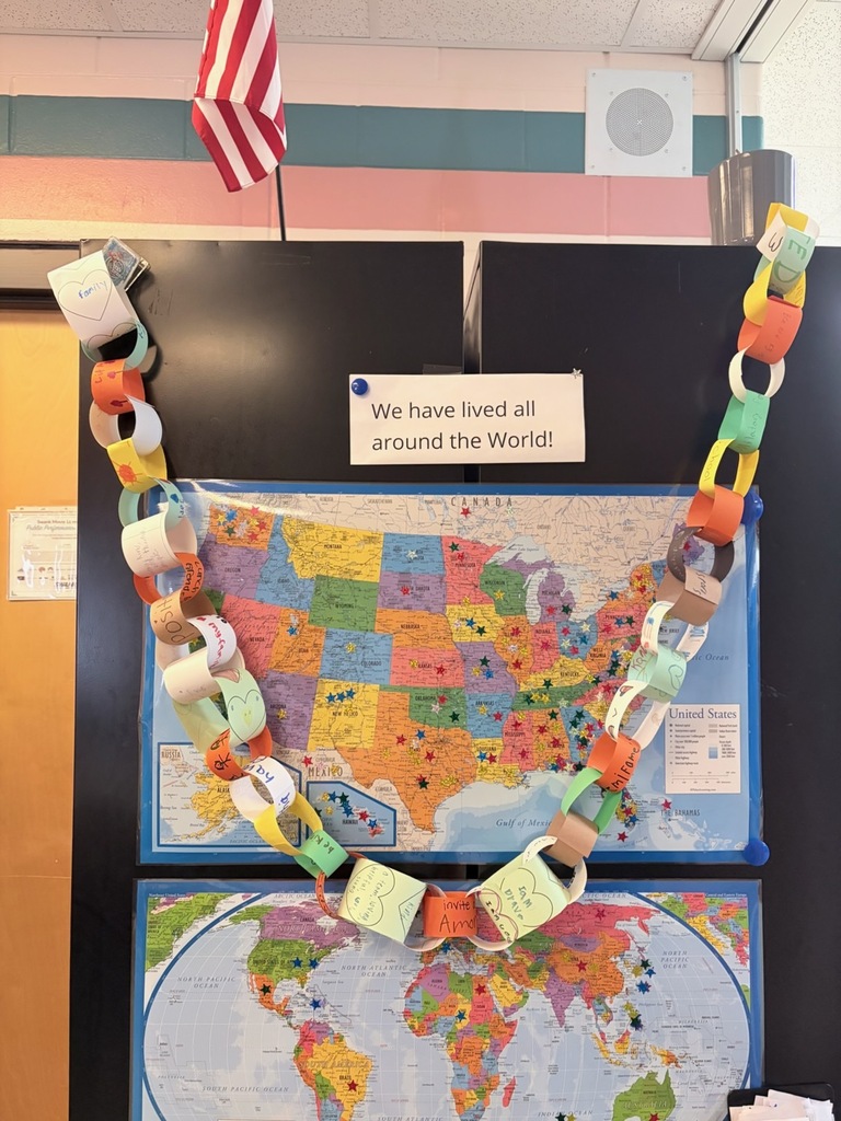 Paper chain on a bulletin board with a US map below. Above it is a sign that reads "We have lived all around the World!"