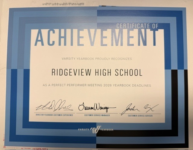 Certificate of achievement in blue and white frame with three signatures and school name. Background is white.