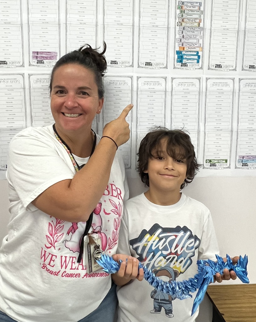 Teacher and student pose for a photo.