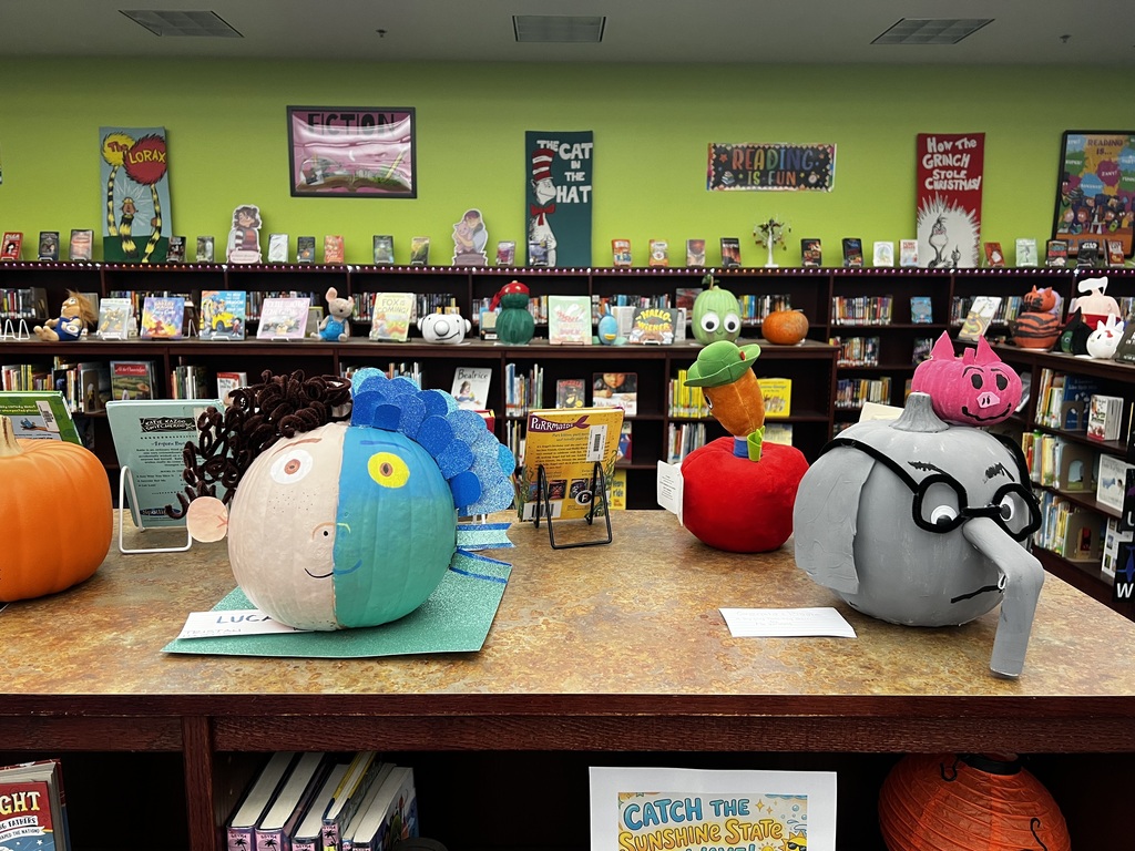 A photo of decorated book character pumpkins.