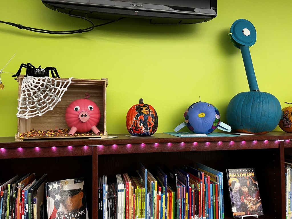 A photo of decorated book character pumpkins.