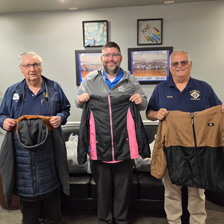 Mr Stone with members from the knights of Columbus with a jacket donation