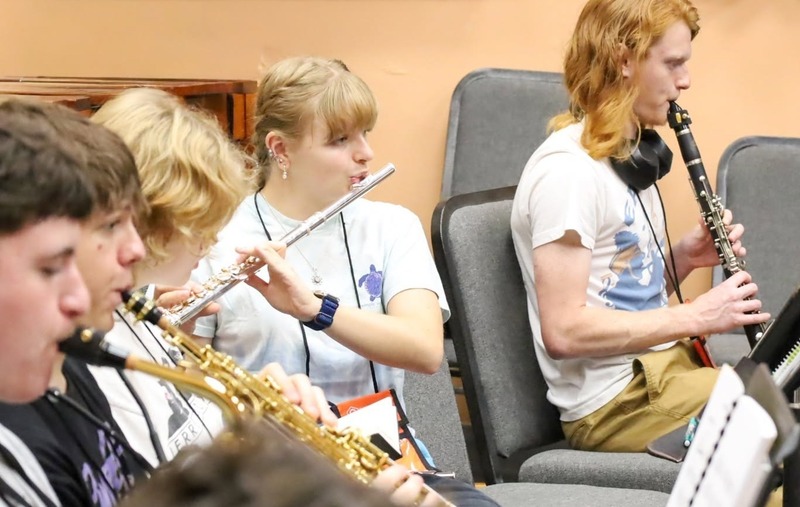 Abigail playing the flute with out students