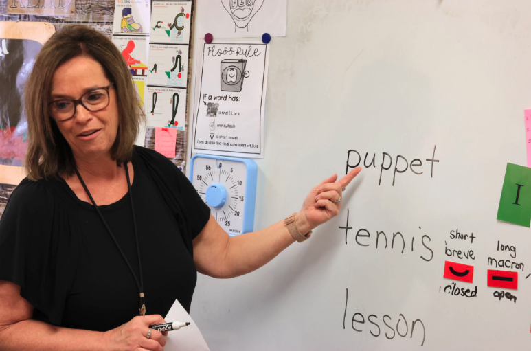 Lincoln Elementary intervention teacher Michelle Coupal works on an Alphabetic Phonics lesson with her first graders.