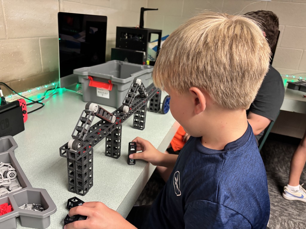 Mr. Lane's 7th grade computers/technology students have been putting their brains to the test this past week! First, they built bridges using a limited "budget" to see which structures could hold a stack of books. Then, they took to the air with their drones! The assignment was to code the drones to fly around the school filming each area, which then would turn into a virtual tour of the building.  #celebrate379