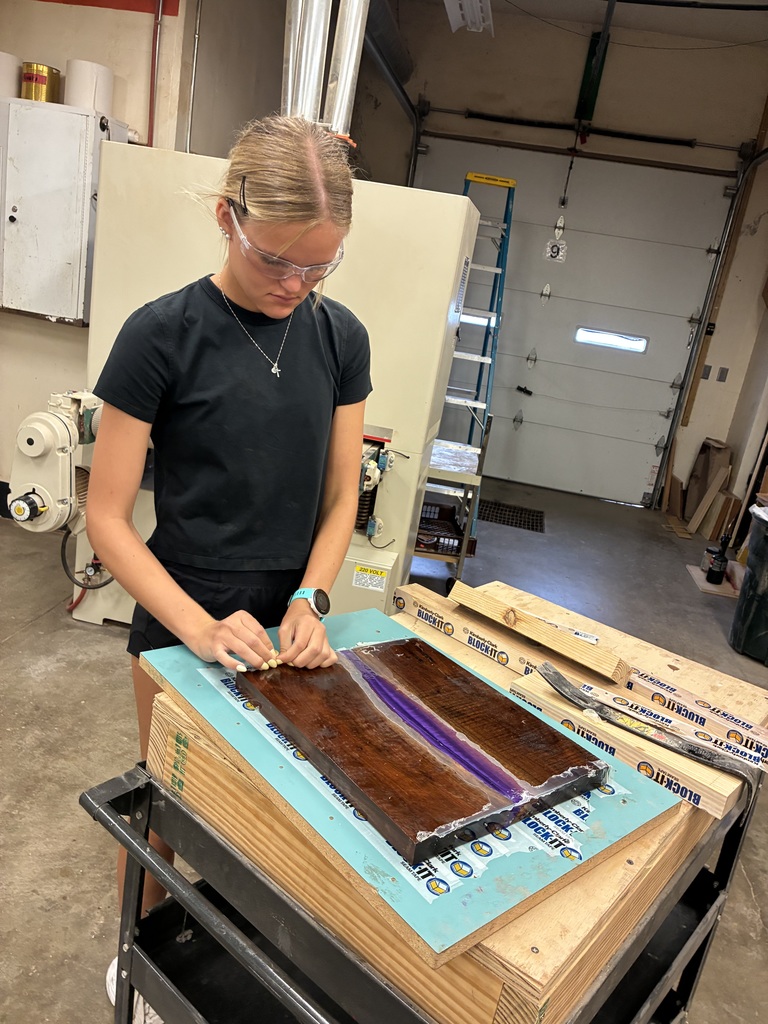 Kylie is interested in Architecture and Design. She thought learning how to build something would be a beneficial experience! She designed and then constructed this nightstand. Mr. Connor was so kind to pop back in to offer support. The top is made out of Walnut with purple Resin.