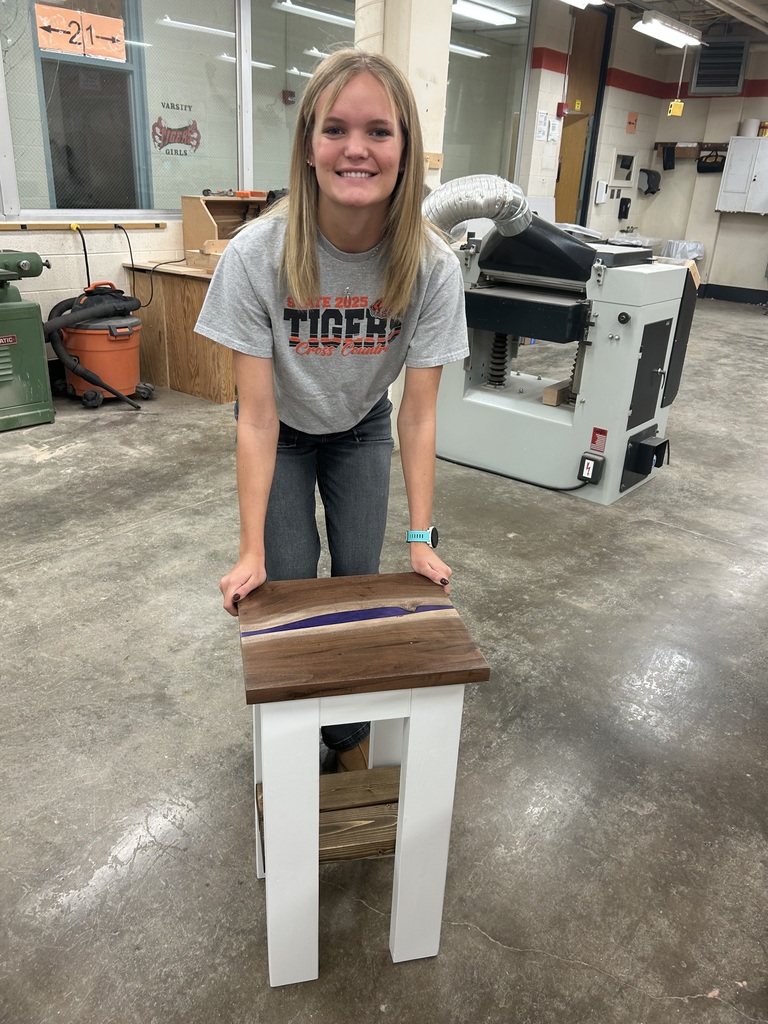 Kylie is interested in Architecture and Design. She thought learning how to build something would be a beneficial experience! She designed and then constructed this nightstand. Mr. Connor was so kind to pop back in to offer support. The top is made out of Walnut with purple Resin.