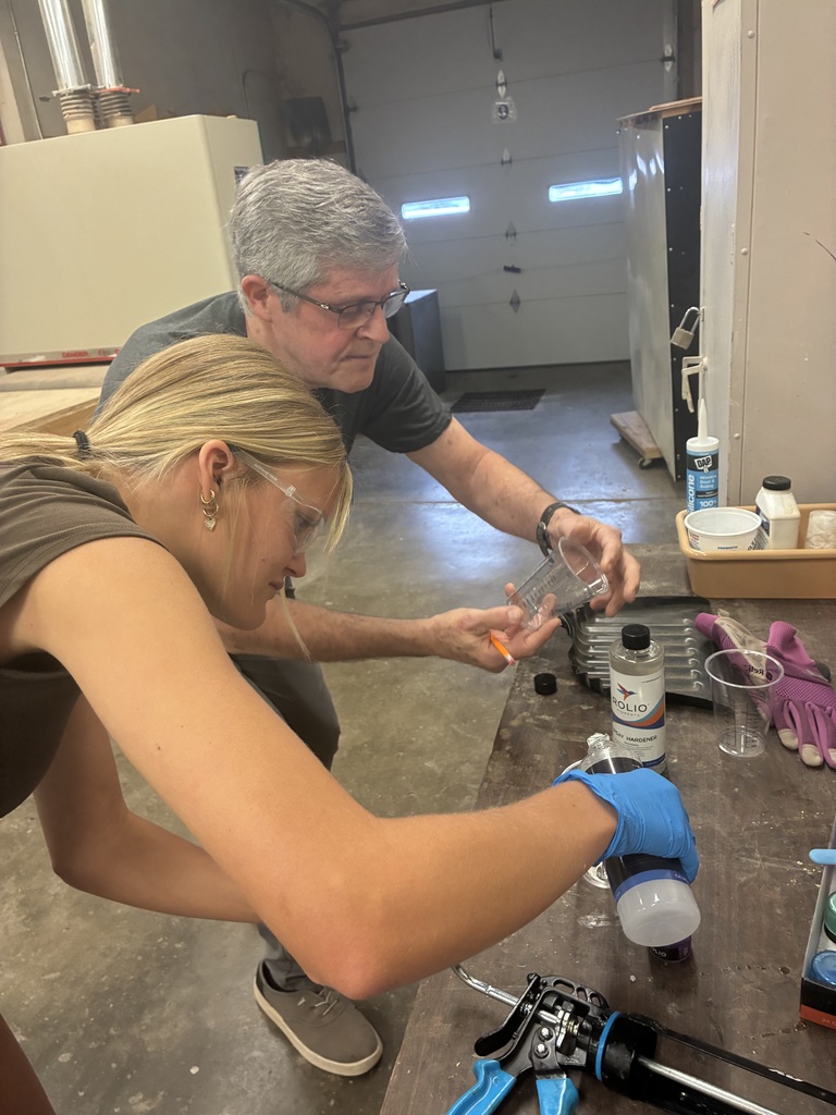 Kylie is interested in Architecture and Design. She thought learning how to build something would be a beneficial experience! She designed and then constructed this nightstand. Mr. Connor was so kind to pop back in to offer support. The top is made out of Walnut with purple Resin.