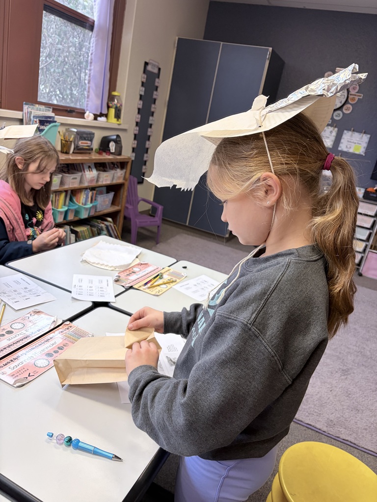 During Ms. Knitter's science class, her second graders explored the different properties of materials used for clothing, such as texture, absorbency, and flexibility. Students were tasked with the challenge to build a hat that best protected them from the sun. They were given aluminum foil, clips, paper bags, paper towels, and string. Creativity ensued! #celebrate379