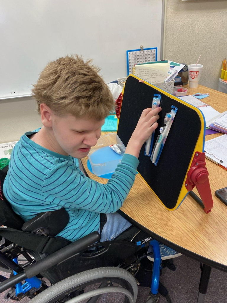 Two Garfield students have been working very hard on life and job skills this school year. They are currently working with a local dentist, Dr. Ferguson, to build the dental bags that are given out at appointments. Chase starts the process by identifying and sorting the items (toothbrush, floss, and toothpaste) and putting them in bins. Morrison then uses the bins, along with a template, to build the set of items needed for each bag. The finished bags will be taken to the dental office for their staff to give to patients. Thank you to Dr. Ferguson's office for supplying the materials for the students to use. It is teaching them important work and life skills! #celebrate379