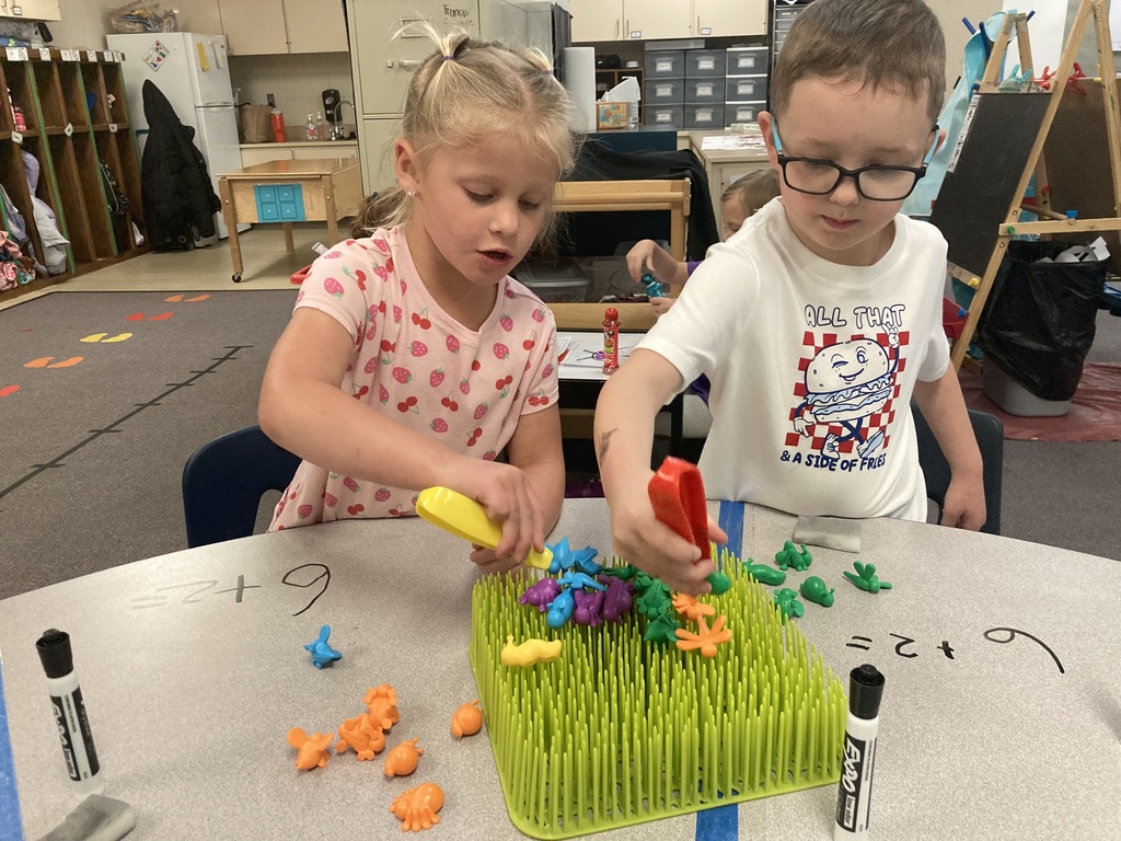Mrs. Bruggeman's Pre-K students had a fun way to write and solve addition problems today! They did this by using their fine motor skills to pluck bugs from the garden and count them. Don’t tell Mrs. Lane, but they also wrote on the tables! #celebrate379