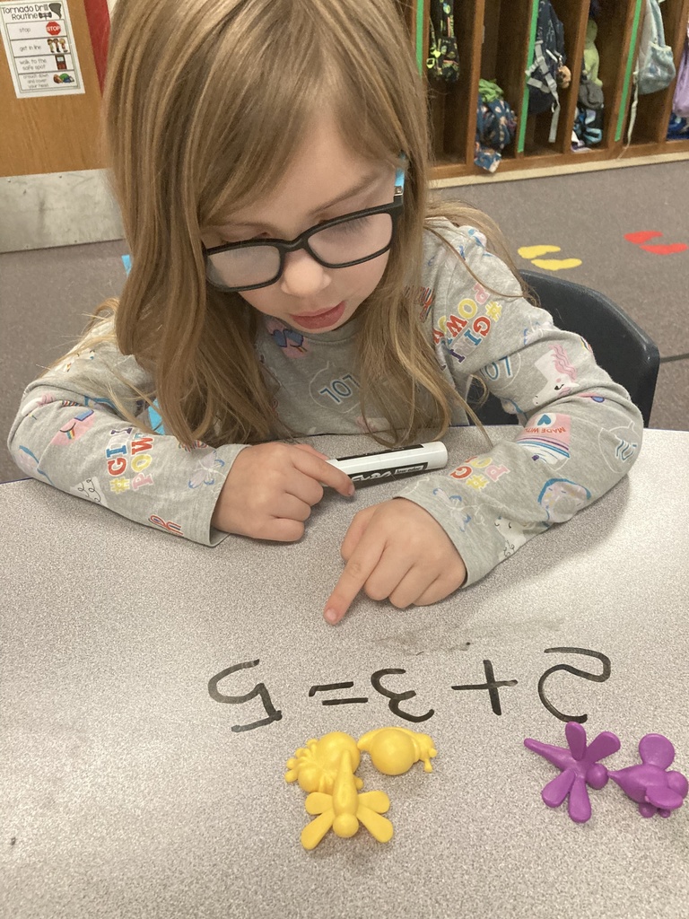 Mrs. Bruggeman's Pre-K students had a fun way to write and solve addition problems today! They did this by using their fine motor skills to pluck bugs from the garden and count them. Don’t tell Mrs. Lane, but they also wrote on the tables! #celebrate379