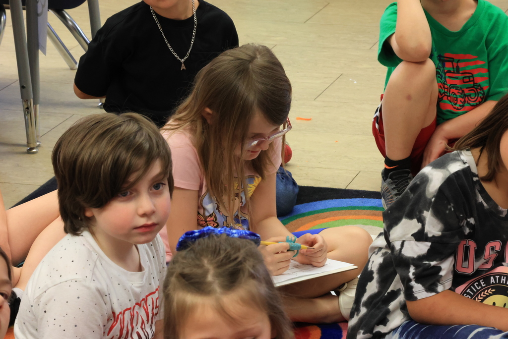 Students take notes as they listen to Mrs. Lange.