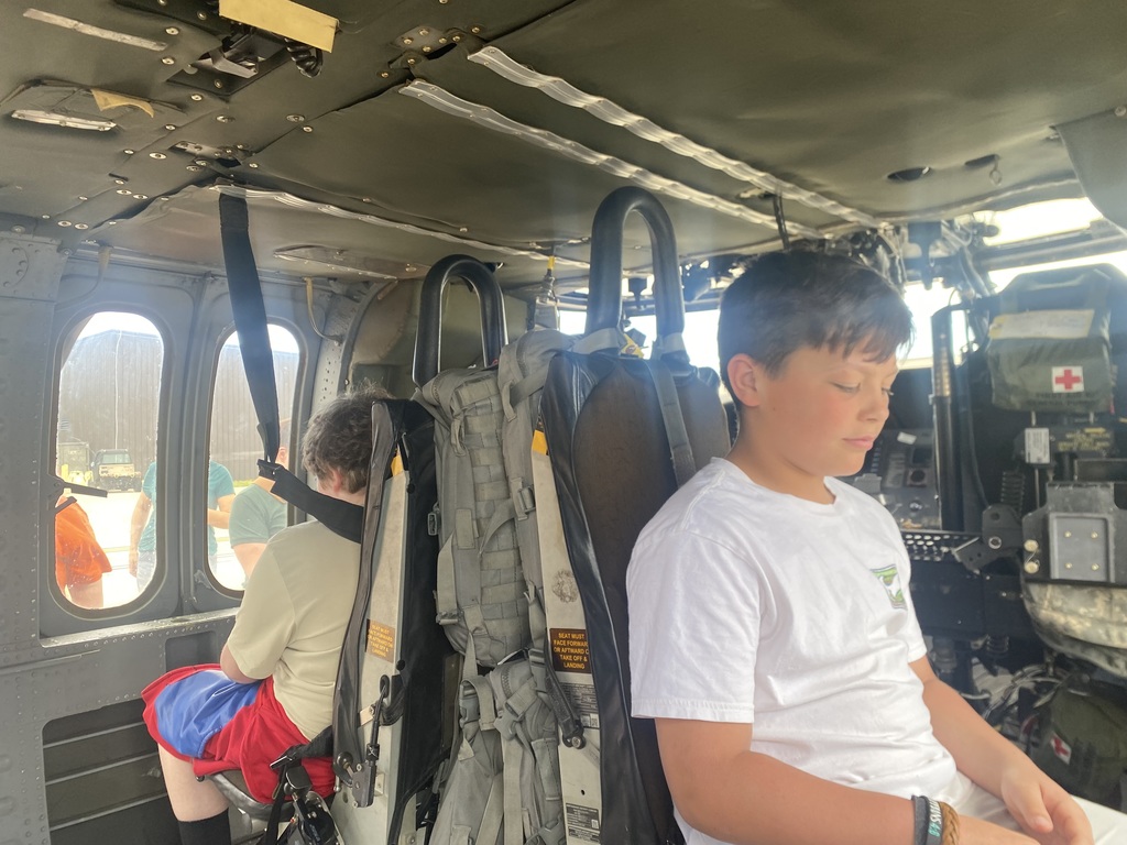 Various 5th graders tour the aviation hangar at Fort Riley and get to sit in a Black Hawk helicopter.