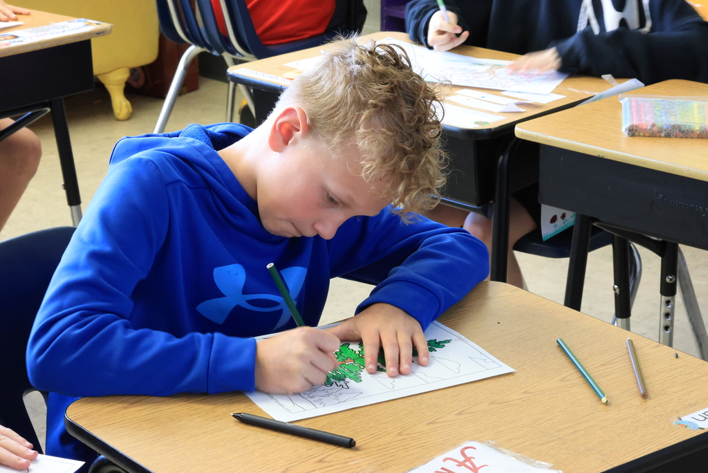 A student colors a tree as part of the upcoming Earth Day celebration at Wakefield Elementary.