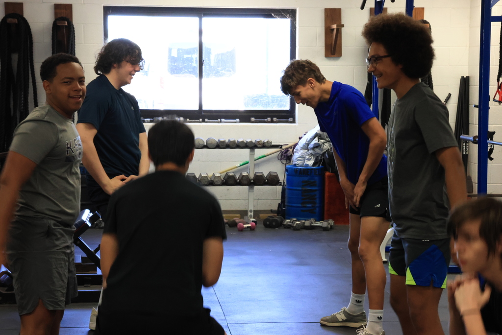 A group of students stretch  in Mr. Freeman's strength and conditioning class.