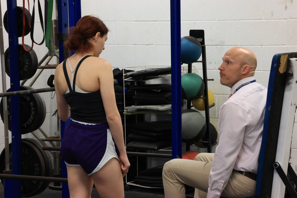 Mr. Freeman talks about the mechanics of a lift to a student.