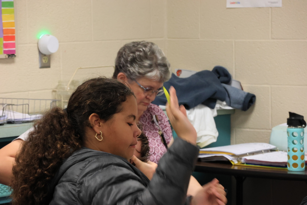 A student writes down answers to review questions in Mrs. Griffiths' math class.