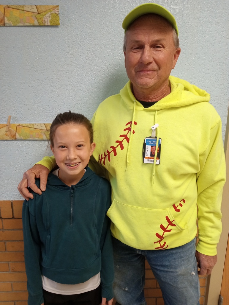 This is a photo of Emma, who won the April "School Bus Behavior Award" from USD 379. She is photographed with her driver, Dolan Rosenow.