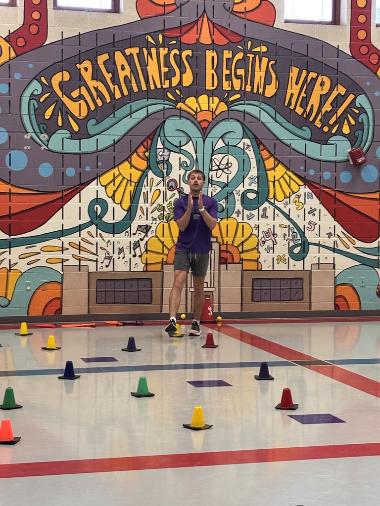 Mr. Beardsley teaches his 2nd graders how to hold and hit a badminton birdie.