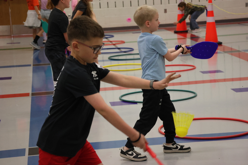 Mr. Beardsley's 2nd grade P.E. class practices holding and serving badminton birdies.
