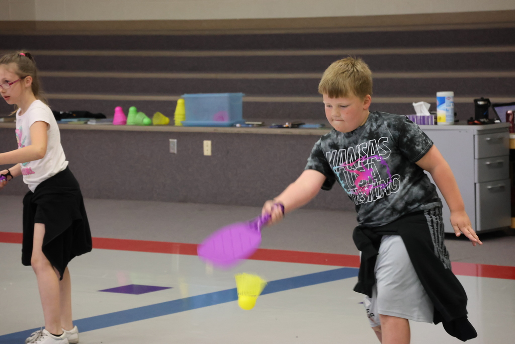 Mr. Beardsley's 2nd grade P.E. class practices holding and serving badminton birdies.