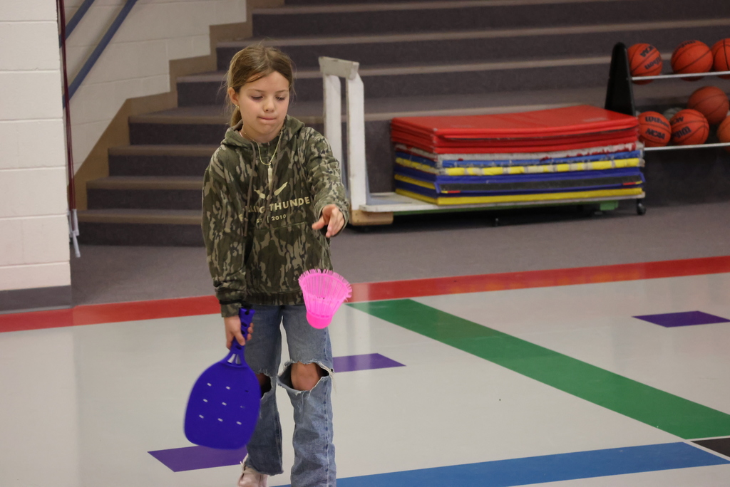 Mr. Beardsley's 2nd grade P.E. class practices holding and serving badminton birdies.