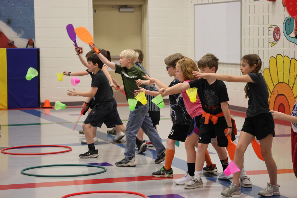 Mr. Beardsley's 2nd grade P.E. class practices holding and serving badminton birdies.