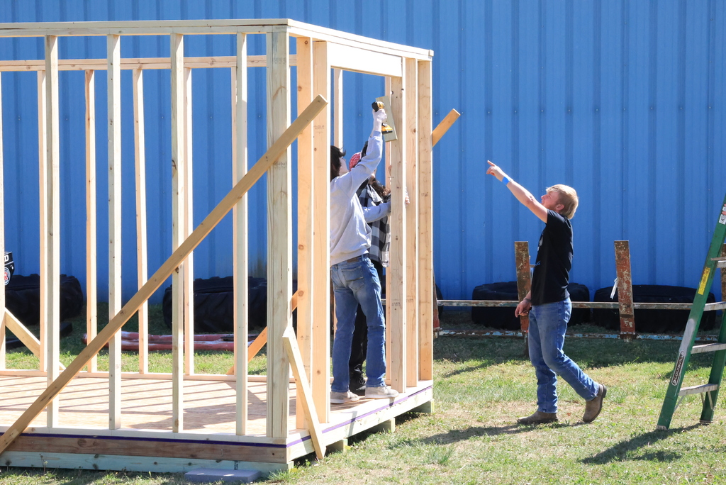 Mr. Couch's industrial arts students work to put up the walls of the 12'x12' shed they are building.