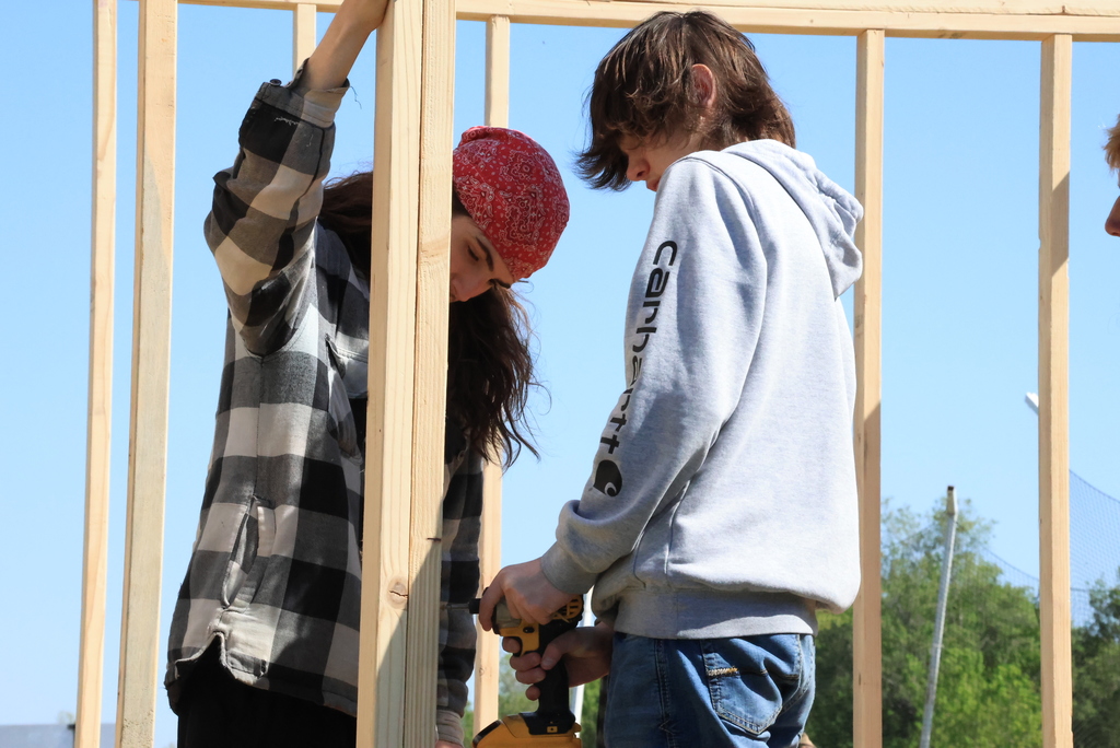 Mr. Couch's industrial arts students work to put up the walls of the 12'x12' shed they are building.