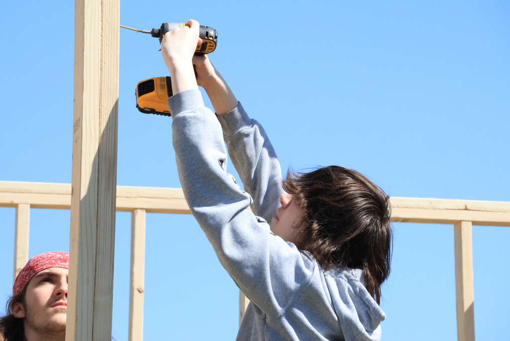 Mr. Couch's industrial arts students work to put up the walls of the 12'x12' shed they are building.