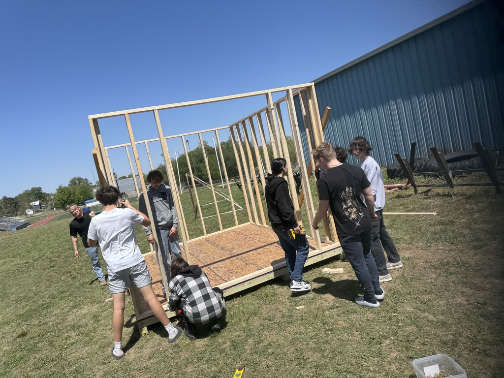 Mr. Couch's industrial arts students work to put up the walls of the 12'x12' shed they are building.