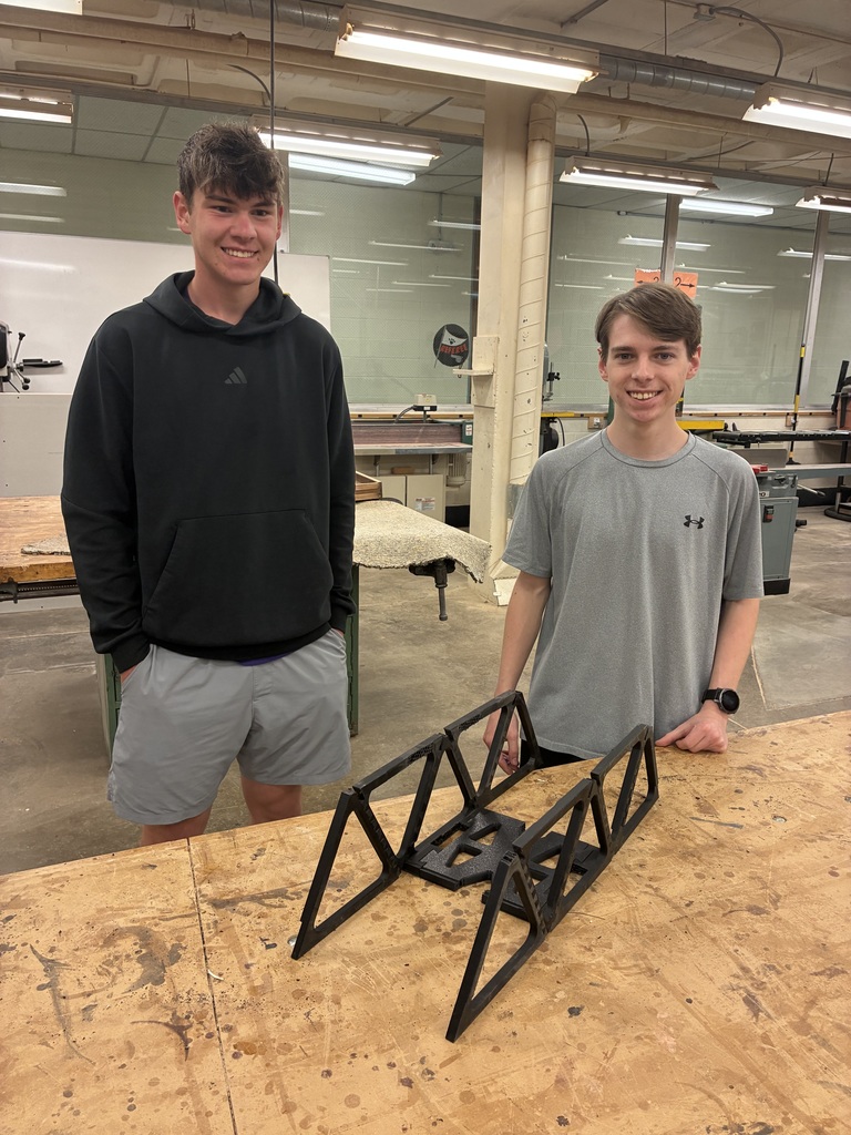 Seniors Caden Peterson and Brody Stenfors show off their completed bridge that was taken to the 3D-Printed Railway Bridge Competition.