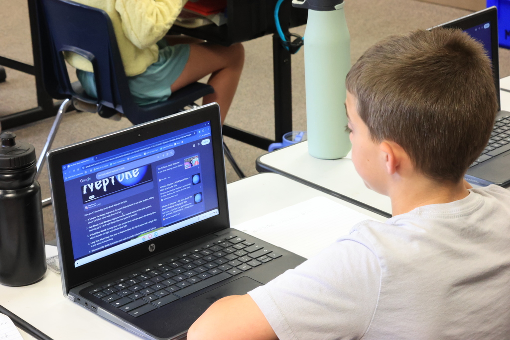 A student looks over planetary data on their laptop as part of their research project.
