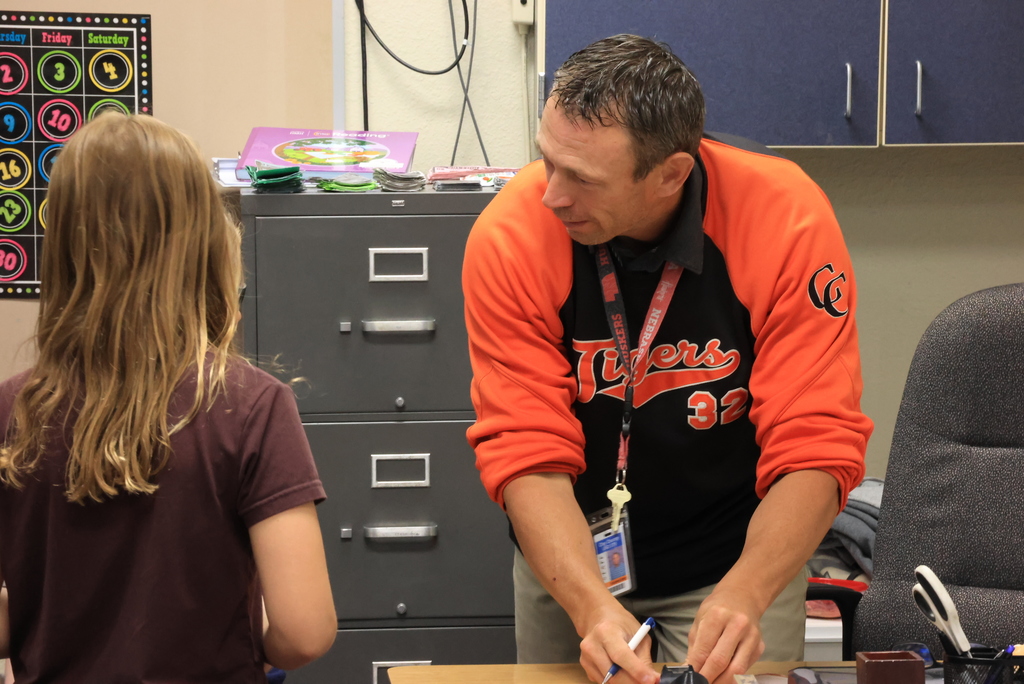 Mr. Bent helps students choose their planet that they will be researching.