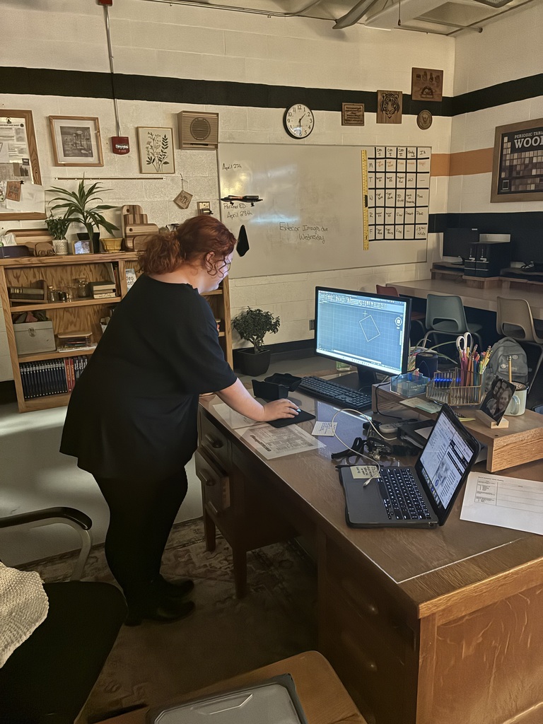 A student in Mrs. Schooley's design-student lab presents their AutoCad command to the rest of the class.