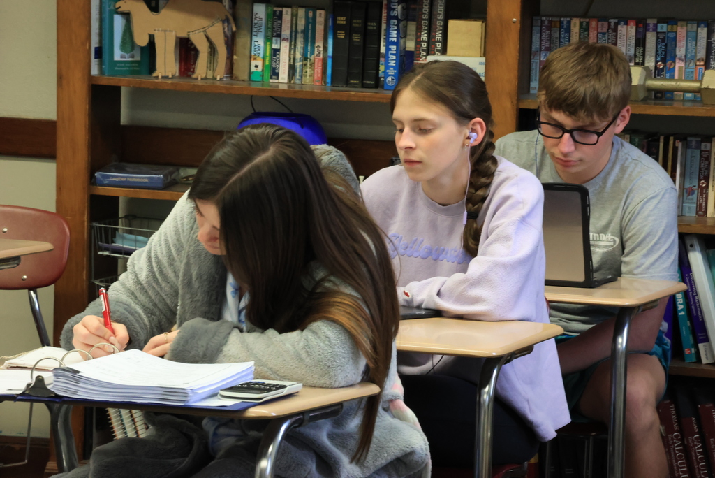Students sit in desks and take notes for Mr. Freeman's physics finals.