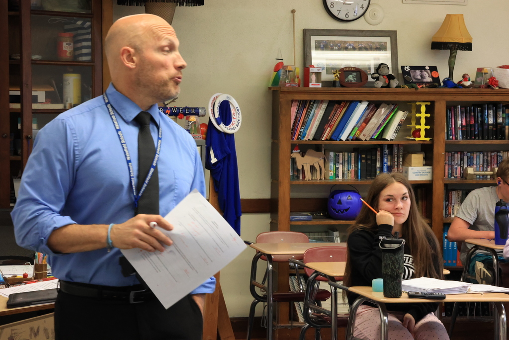 Mr. Freeman stands in front of his class and helps his physics students review for their upcoming final.