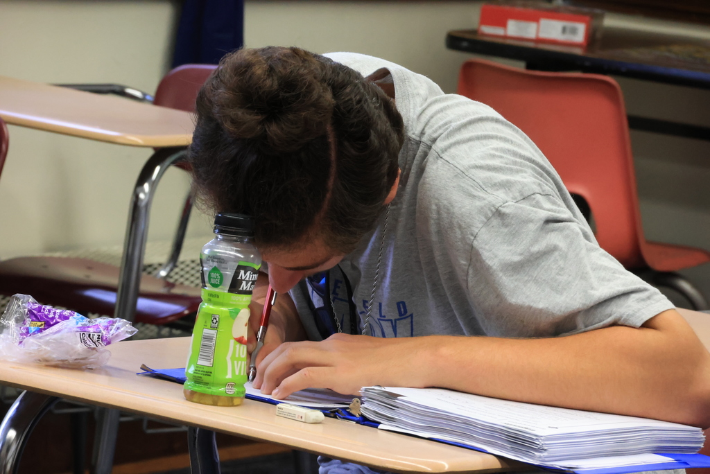 Students sit in desks and take notes for Mr. Freeman's physics finals.