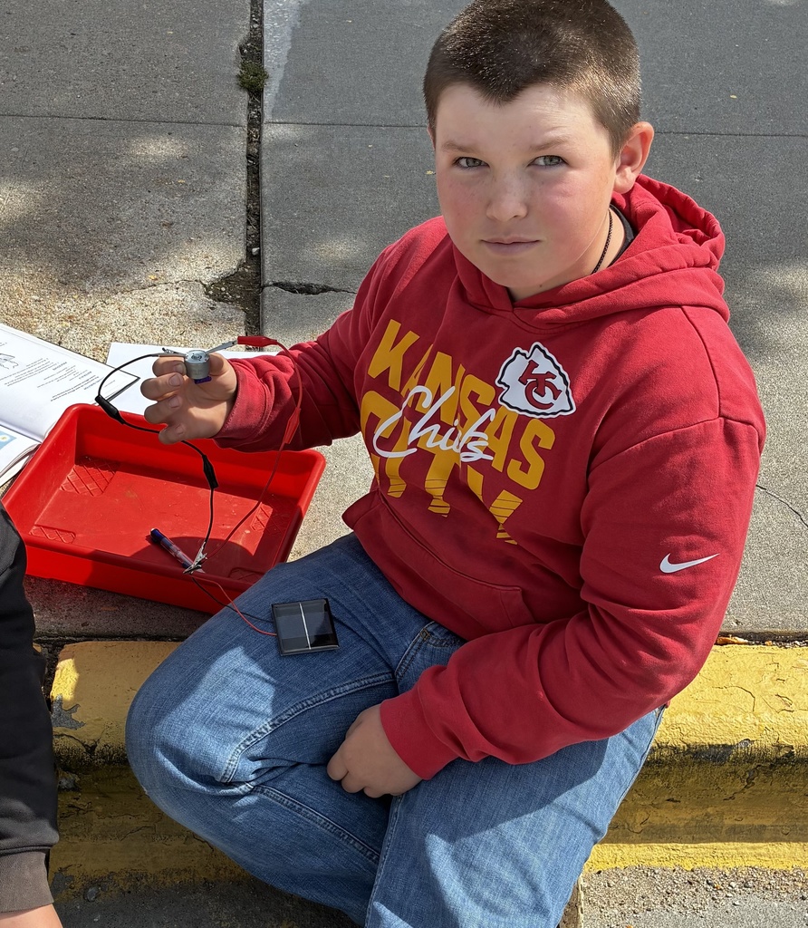 A group of 6th graders in Mr. Walsh's class use a model to determine how the Sun's angle relates to the amount of solar energy received at a given area on Earth's surface.
