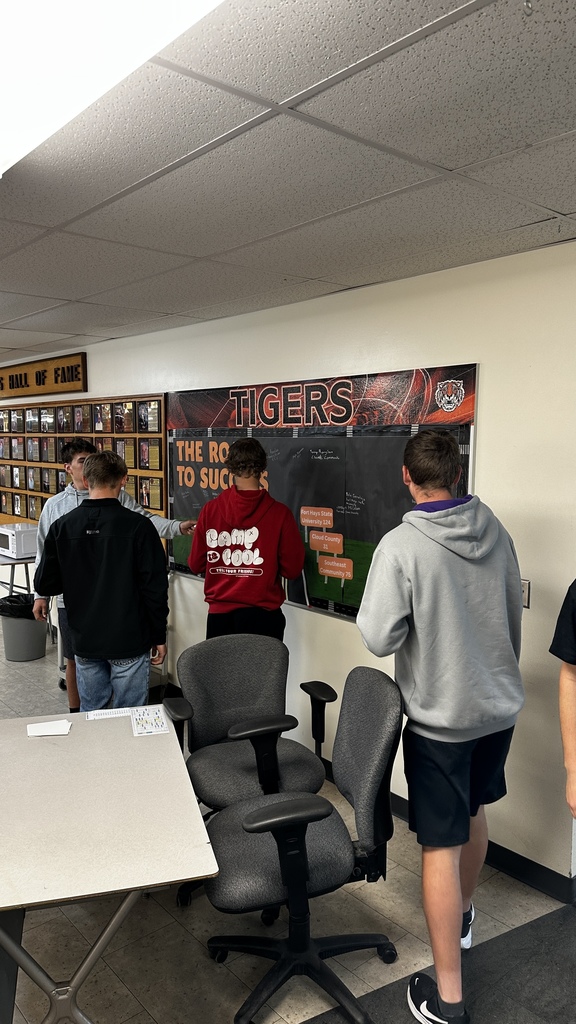 Students take turns signing "The Road to Success" board in the commons signifying where they will be attending school next year.