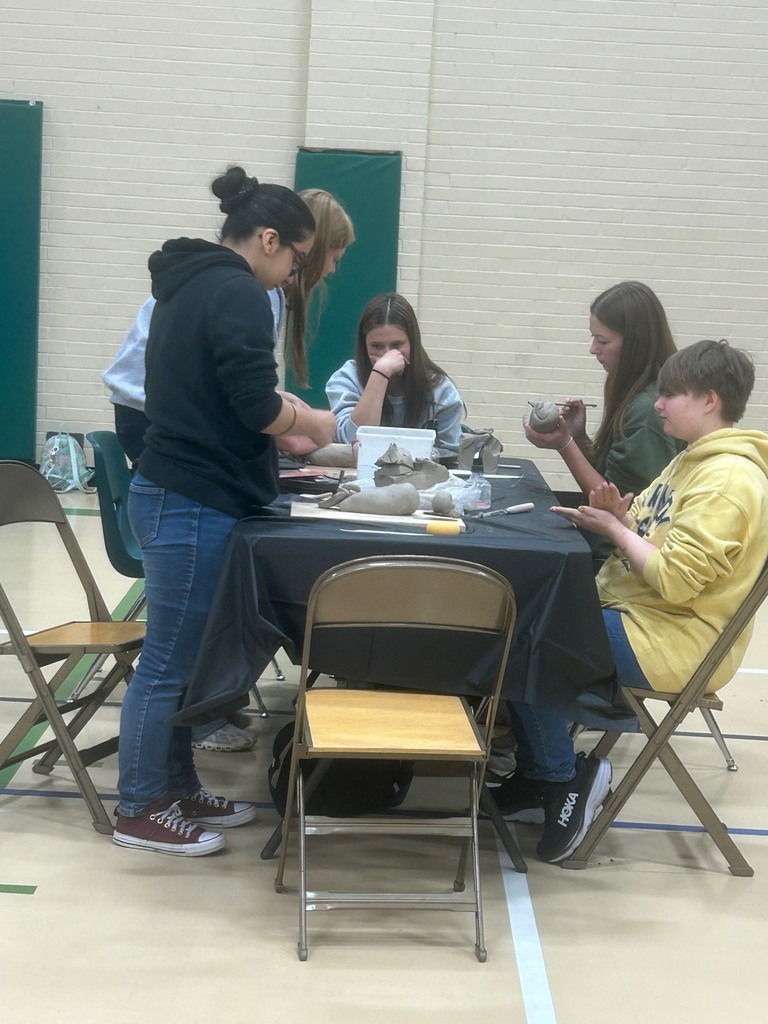 Students work on their art pieces at the NCKL art show in Chapman.