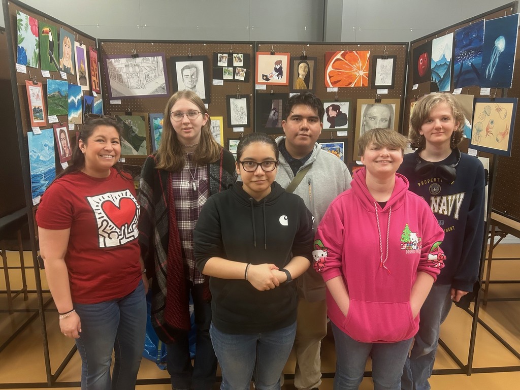 Students pose for a photo at the Fort Hays High School art show.