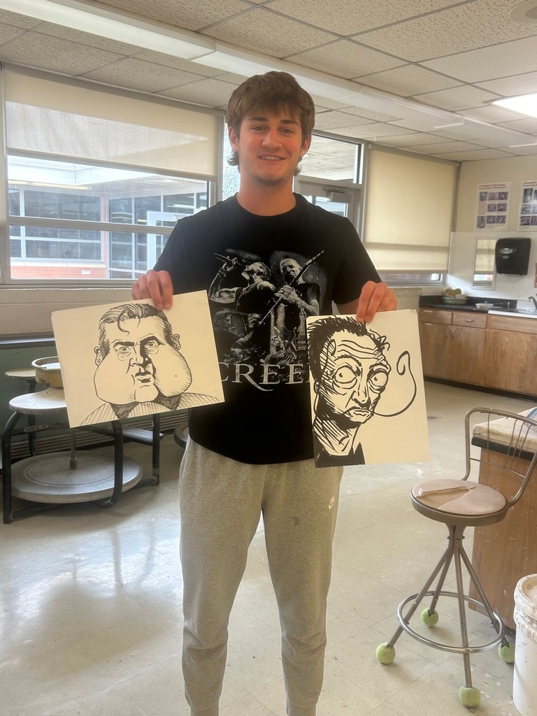 A student shows off his pieces that he entered into art shows in April.