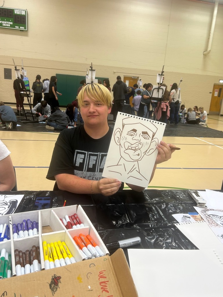 A student shows off his pieces that he entered into art shows in April.