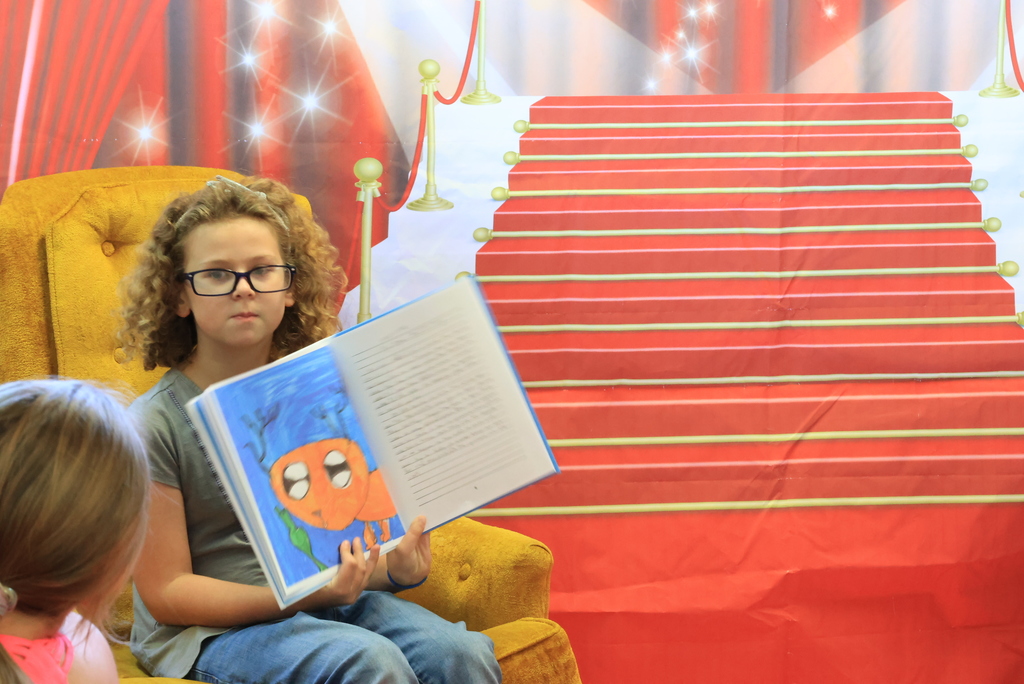 A student reads from the class book.