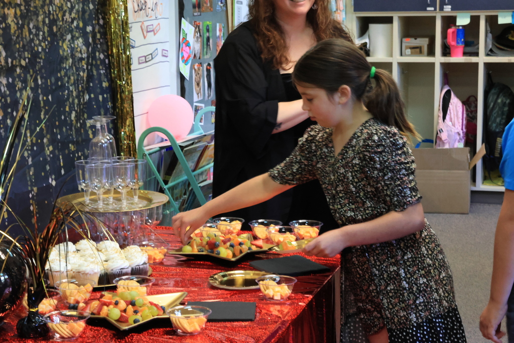 Students get snacks before the class reading of their published book.