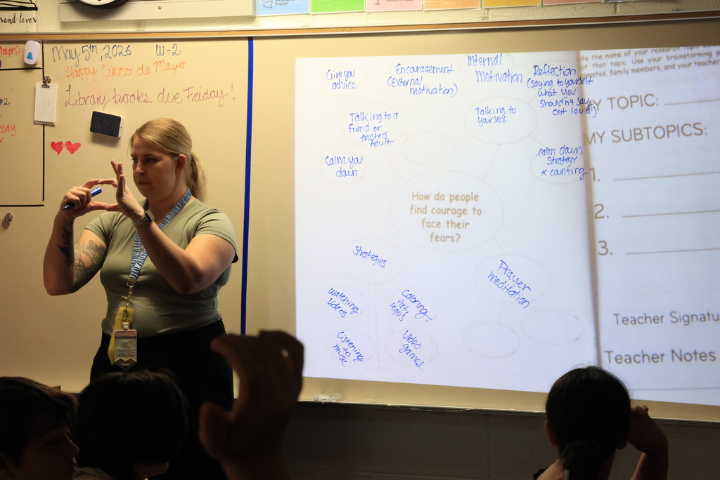 Mrs. Crabtree writes ideas about facing fear on the board as students give their suggestions.