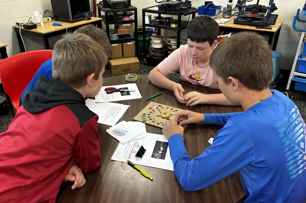 Students smile as they try out their review game that they created to prepare for end-of-year testing.