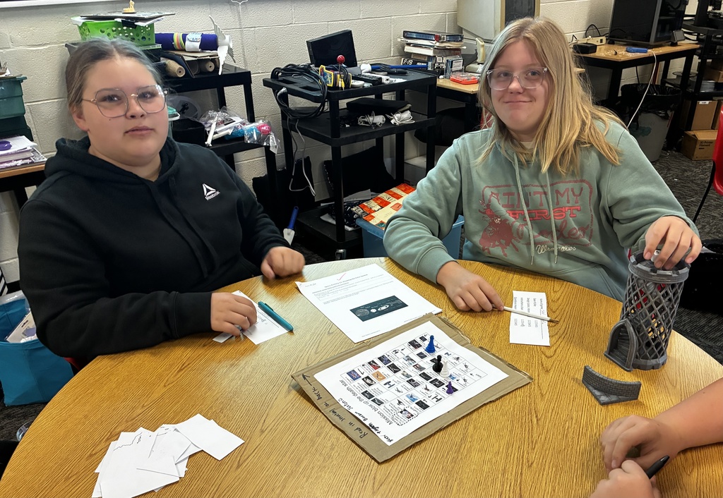 Students smile as they try out their review game that they created to prepare for end-of-year testing.